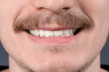 Young man with healthy teeth smiling. Closeup