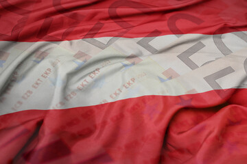 waving colorful national flag of austria on a euro money banknotes background. finance concept.