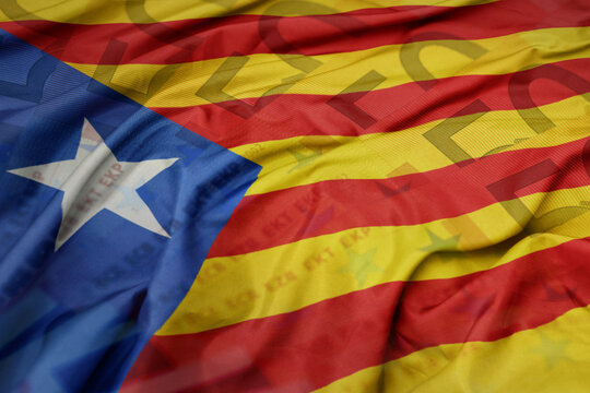 waving colorful national flag of catalonia on a euro money banknotes background. finance concept.