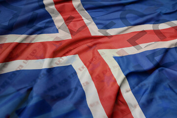 waving colorful national flag of iceland on a euro money banknotes background. finance concept.