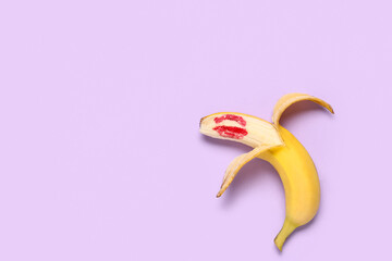 Fresh banana with lips print on purple background. Sex education