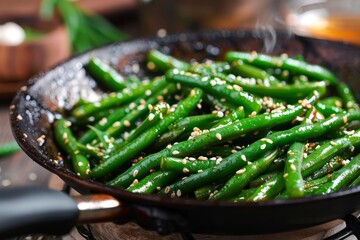 Green beans with sesame in pan, steam visible