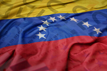 waving colorful national flag of venezuela on a euro money banknotes background. finance concept.