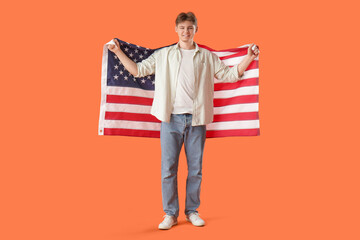 Young man with flag of USA on orange background