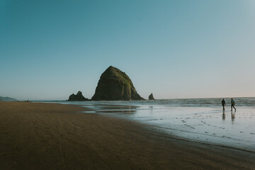 People walking on Cannon Beach.
