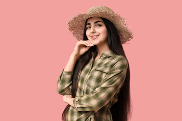 Beautiful young happy woman in straw hat on pink background. Festa Junina (June Festival) celebration