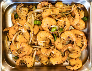 A hot table tray of Chinese Szechuan Chili Pepper Shrimp in a food court kiosk