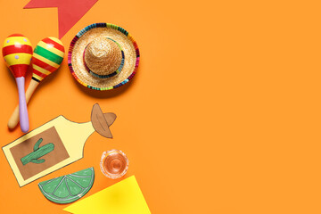 Obraz premium Mexican maracas with sombrero, tequila and decor on orange background. Cinco de Mayo