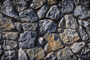 grey stone dark wall of medieval horizontal stones facade background 4