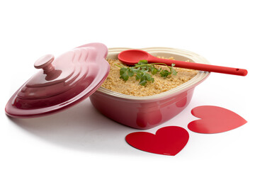  a pink heart shaped casserole dish for a valentines dinner at home isolated on white