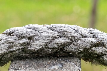A rope is wrapped around a stone, and it is covered in frost