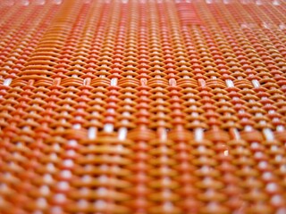 The orange and white woven fabric has a pattern of triangles