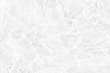 White water with ripples on the surface. Defocus blurred transparent white colored clear calm water surface texture with splashes and bubbles. Water waves with shining pattern texture background - obrazy, fototapety, plakaty