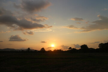 Sunset Sky Clouds in the evening with Red, Orange, Yellow and purple sunlight on Golden hour after sundown.