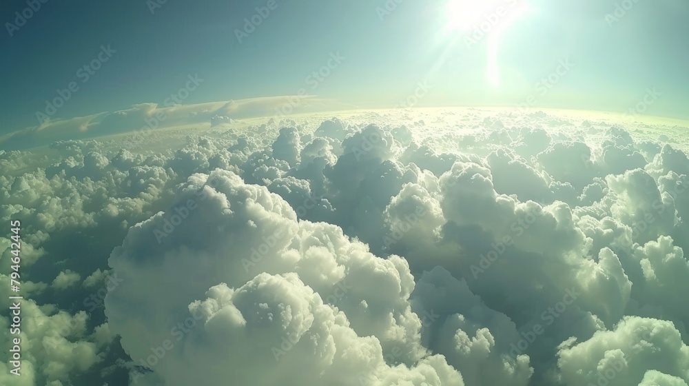 Poster the sun is visible high above a layer of clouds in the sky, casting light and warmth onto the scene 