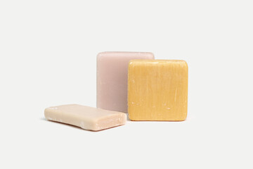 Soaps of different colors and shapes on a white background