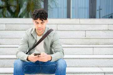 young handsome man using smartphone