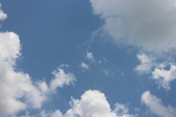 Summer blue sky background with white clouds.