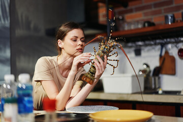 Elegant woman enjoying a fresh lobster dish at a stylish restaurant table with white tablecloth