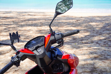 motorbike on the beach in Thailand. Blue sea and yellow sand. There is space for text for your...