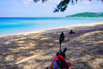 motorbike on the beach in Thailand. Blue sea and yellow sand. There is space for text for your...