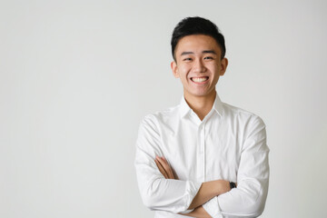 Portrait of healthy, cheerful handsome young Asian man smiling and looking at camera with white background. Happy, health and mental healthcare concept