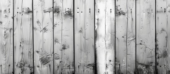This close-up photo captures a wooden fence in monochrome, showcasing the intricate details and texture of the weathered wood