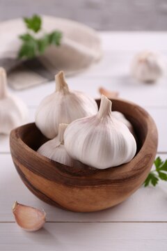 Fresh garlic on white wooden table, closeup