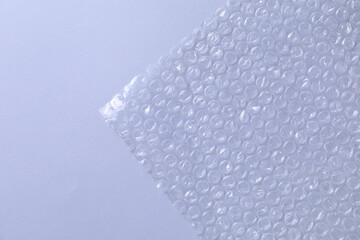 Transparent bubble wrap on gray background, top view. Space for text