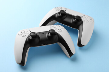 Wireless game controllers on light blue background