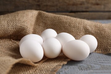 Fresh chicken eggs on grey wooden table, closeup