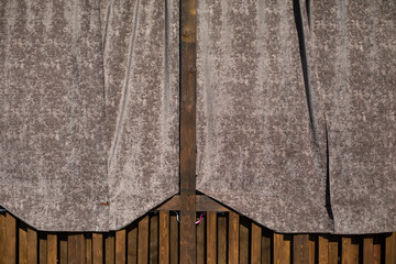 Curtain on the veranda. Fabric on a wooden veranda. Wooden construction.