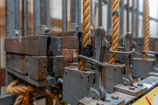 Older theatrical rigging system with twisted manila rope and weights found back stage.