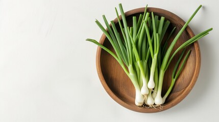 Green onion in wooden bowl isolated on the white background. Top view.