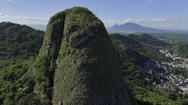 Drone flies close to large rock in Parque Estadual da Fonte Grande with amazing views of Vitoria, Espirito Santo, Brazil