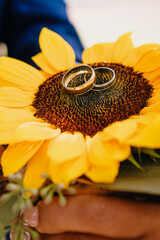 wedding rings on a sunflower