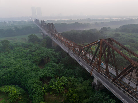 Aerial drone view of Long Bien bridge at dawn in Hanoi, Vietnam - Powered by Adobe
