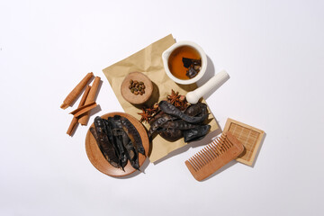 Flat lay herbs and wooden tools on minimalist background with the main composition is black locust...
