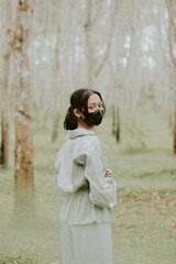 woman in black mask in the forest