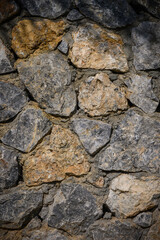 Stone wall texture. Decorative uneven cracked real stone wall surface. 3