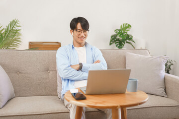 Business at home concept, Businessman wears bluetooth headphones to watching movie with having fun