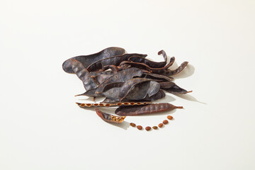 A pile of black locust pods isolated on white background from high angle shot. Vacant space for...