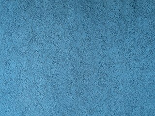 Rough, stucco blue concrete wall surface. Background texture.