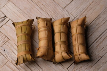 Lepet is a snack made from sticky rice and grated coconut and seasoned with salt, wrapped in young...
