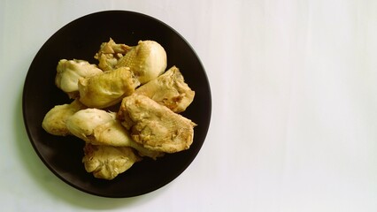 Raw chicken meat fillet, thigh, wings and legs on a white background. Top view with copy space.