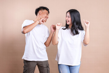 Asian man and woman couple wearing white t-shirt for mockup on beige background.