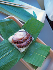 Traditional Japanese tako octopus oshizushi pressed sushi wrapped in a leaf © Eugene