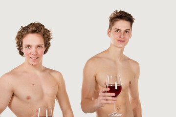 Gay couple. Two young attractive guys are drinking red wine.