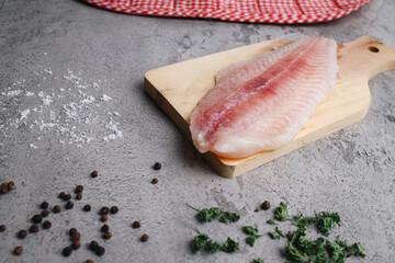Raw Seafood of Fresh Dory Fillet on Gray Background