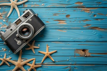 A blue wooden background adorned with a starfish and an old photo camera conjures a seaside nostalgia, blending memories of exploration and captured moments.






